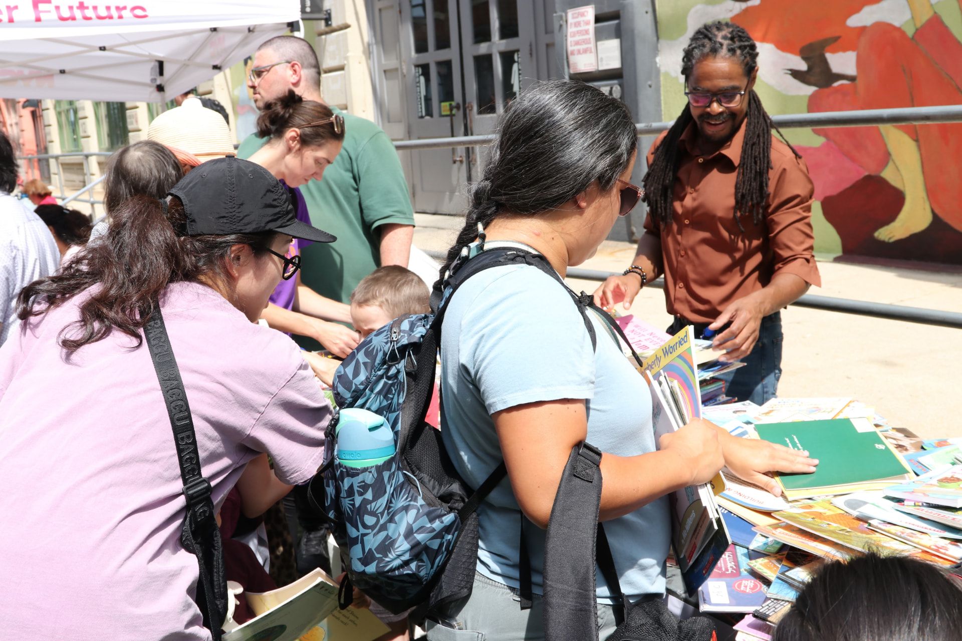 Neighbors browsing school supplies at a community event